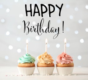 Image of Happy Birthday! Delicious cupcakes with burning candles on white table