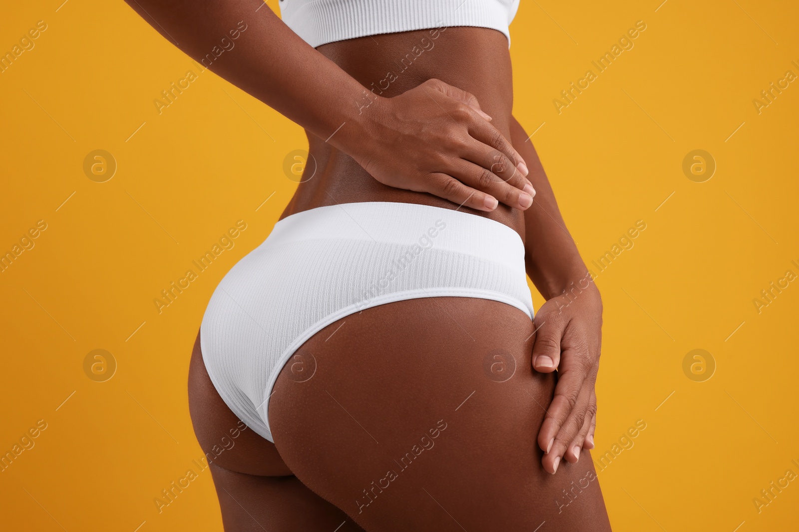 Photo of Woman in stylish bikini on yellow background, closeup