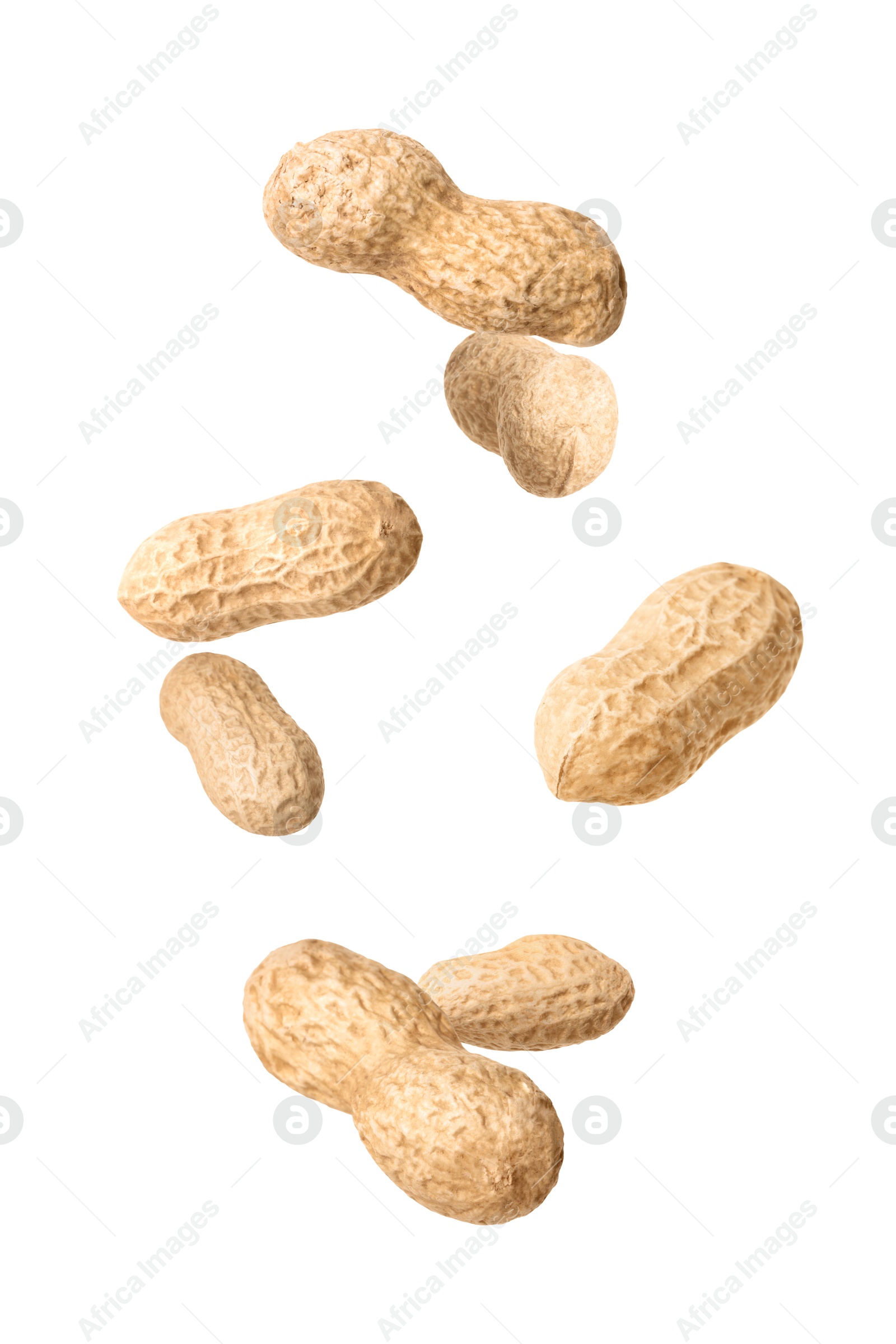 Image of Unpeeled peanuts in air on white background