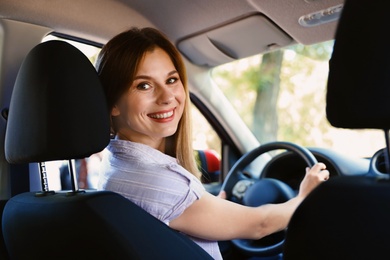 Photo of Happy beautiful woman driving modern car