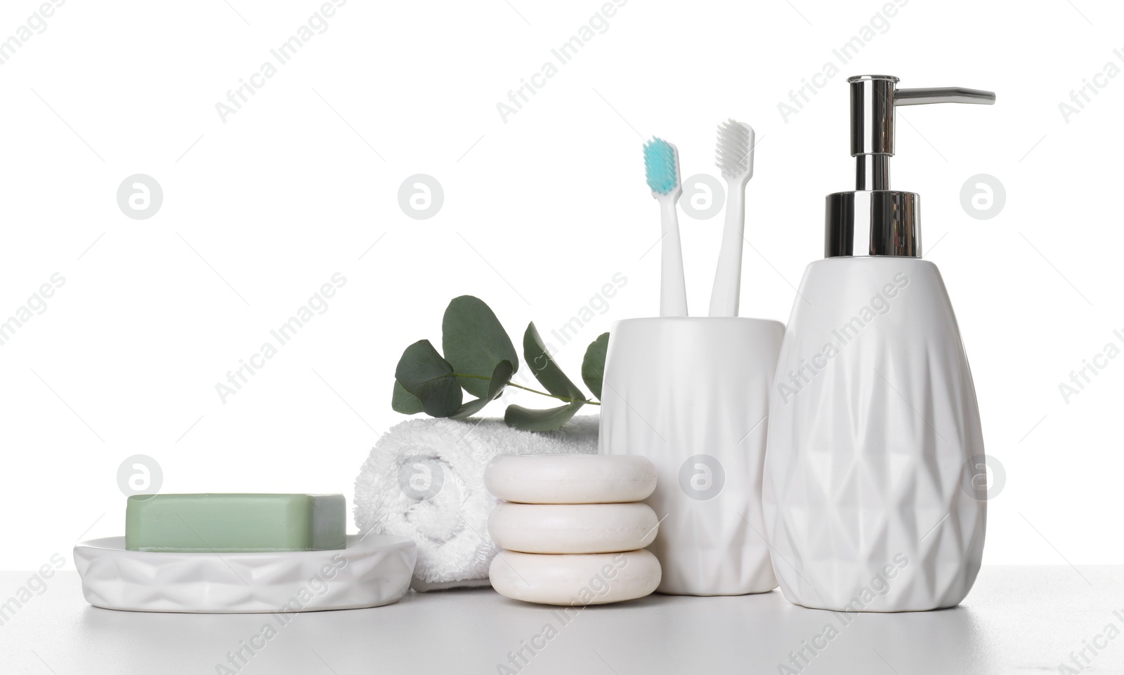 Photo of Bath accessories. Different personal care products and eucalyptus branch on table against white background