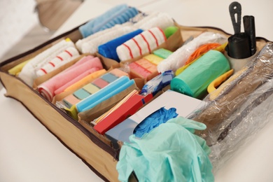 Photo of Large organizer with cleaning supplies on table indoors