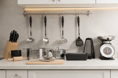 Set of different utensils on countertop in kitchen