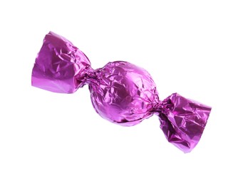 Photo of Tasty candy in violet wrapper isolated on white