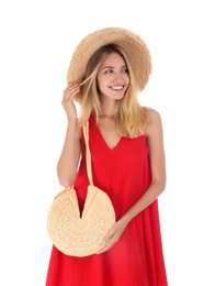 Beautiful young woman with stylish straw bag on white background