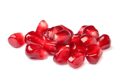 Tasty juicy pomegranate seeds on white background