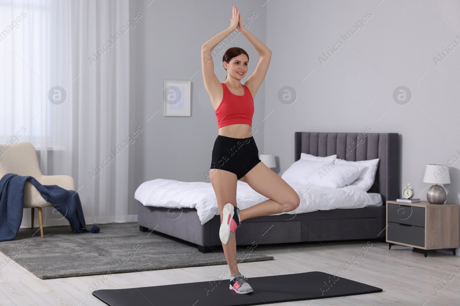 Photo of Happy woman doing morning exercise at home