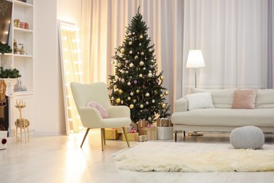 Photo of Beautiful Christmas tree near sofa in living room