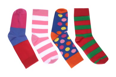 Photo of Different colorful socks on white background, top view