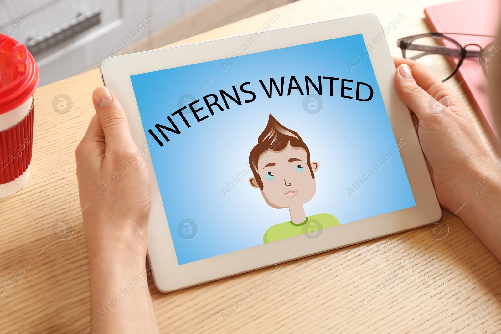 Image of Woman with tablet at wooden table, closeup. Interns wanted