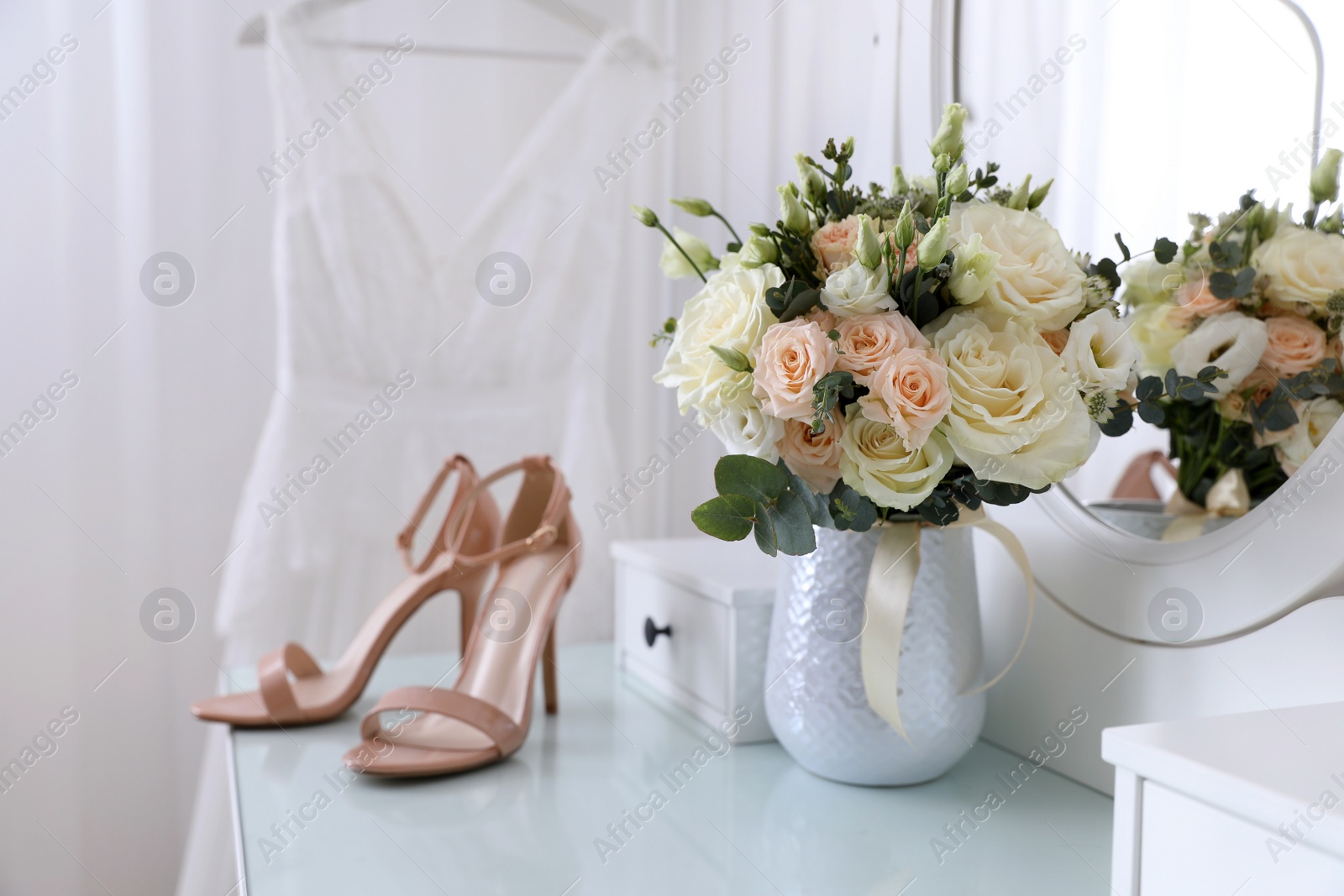 Photo of Wedding bouquet, shoes and dress in room