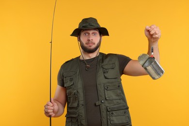 Fisherman holding rod and tin can on yellow background