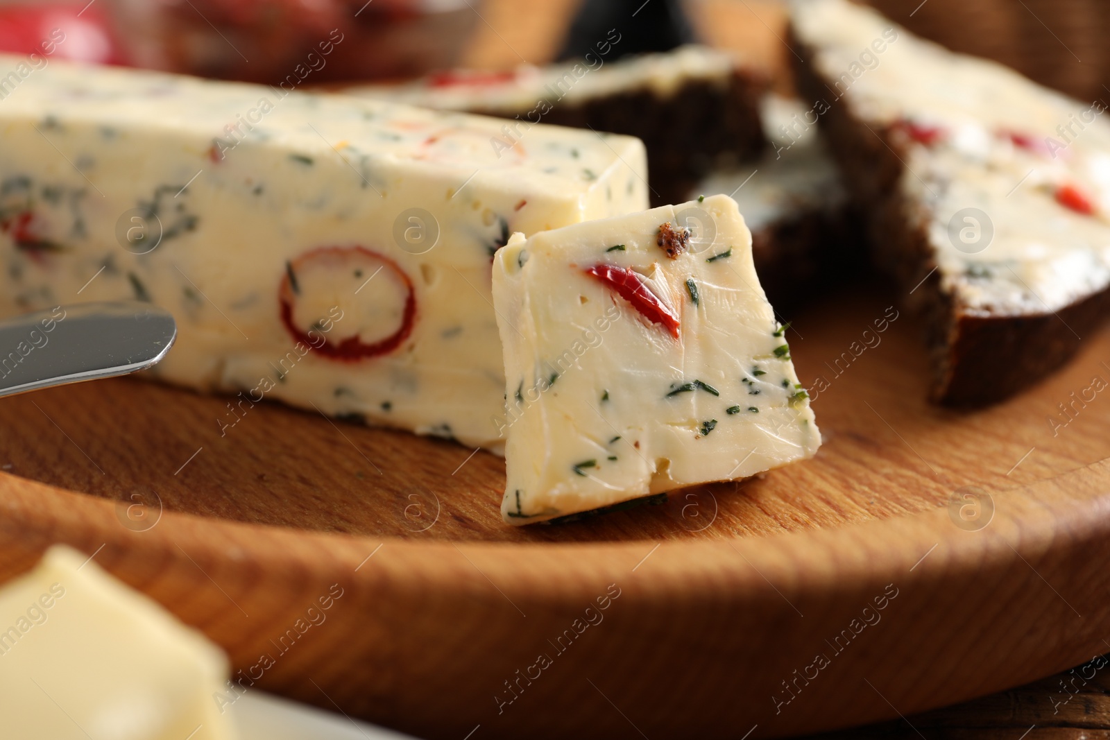 Photo of Tasty butter with dill and chili pepper on table, closeup