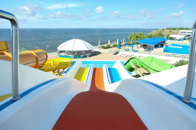 Photo of View from colorful slide in water park on sunny day