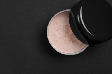 Photo of One open face powder on black background, top view. Space for text