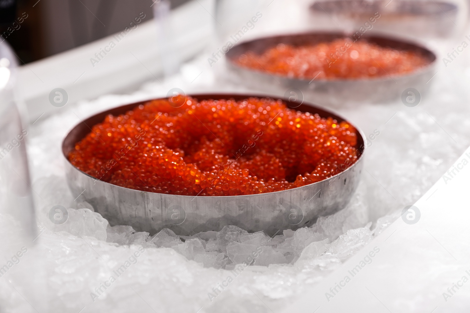 Photo of Delicious red caviar on ice. Wholesale market