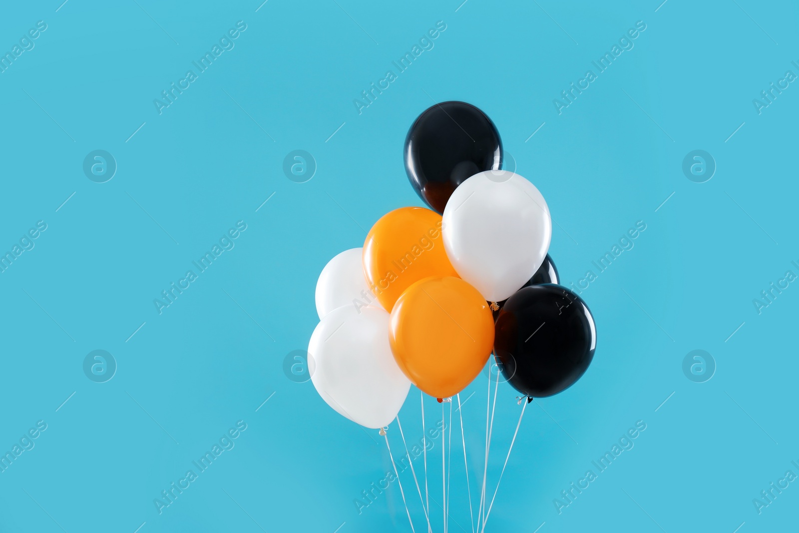 Photo of Colorful balloons on blue background. Halloween party