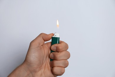 Photo of Man holding lighter on white background, closeup