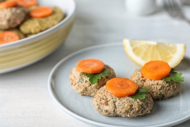 Plate of traditional Passover (Pesach) gefilte fish on table, closeup