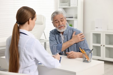 Photo of Arthritis symptoms. Doctor consulting patient with shoulder pain in hospital