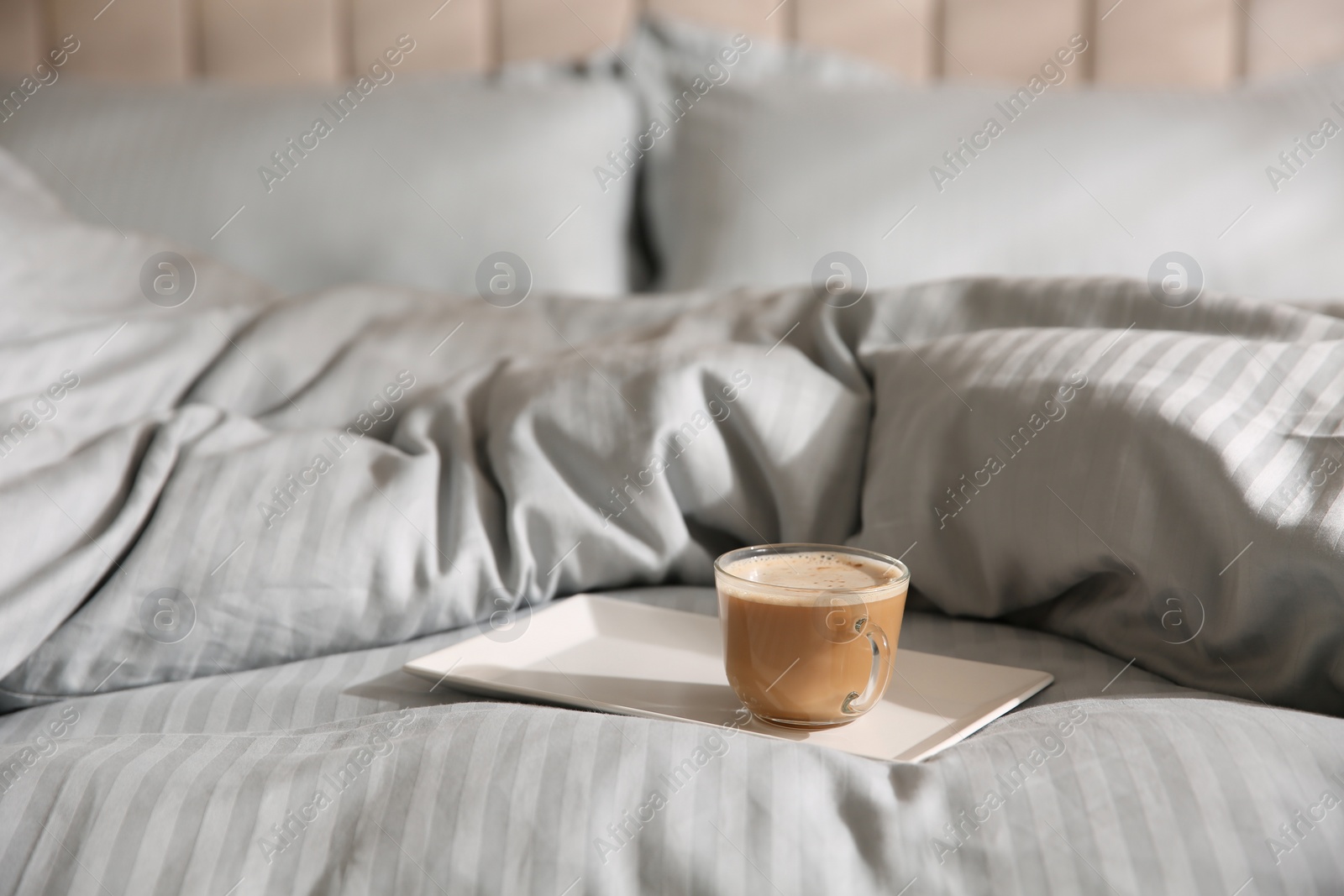 Photo of Tray with morning coffee on soft blanket. Space for text