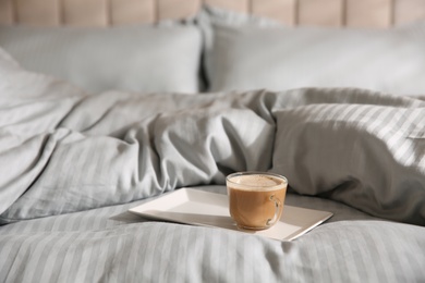 Tray with morning coffee on soft blanket. Space for text