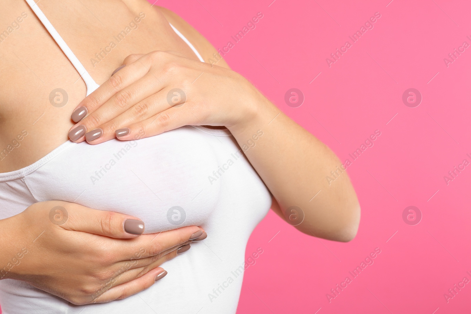 Photo of Woman checking her breast on color background, closeup. Space for text