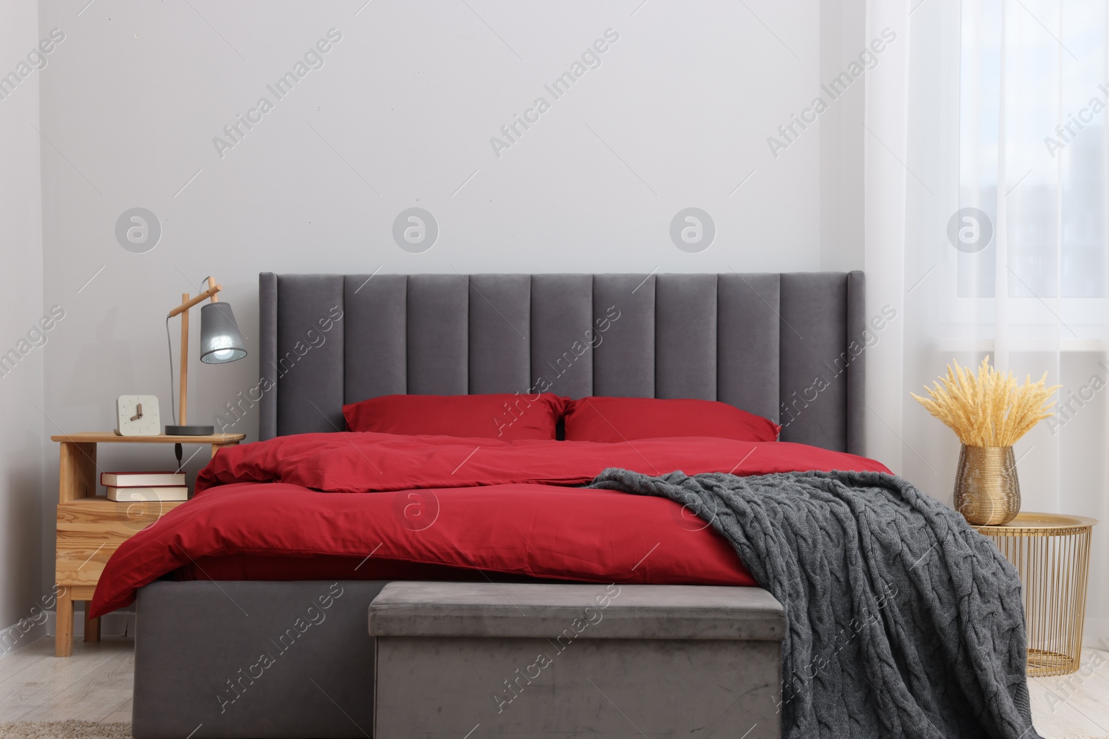 Photo of Stylish bedroom with comfortable bed and bedside table. Interior design