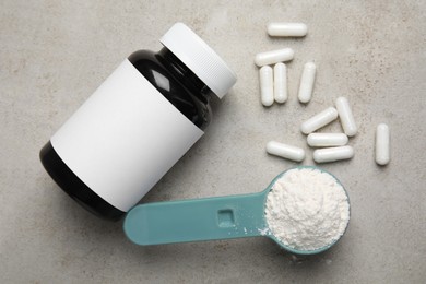 Photo of Amino acid pills and powder on grey table, flat lay