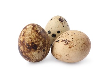Photo of Beautiful speckled quail eggs on white background