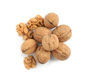 Pile of ripe walnuts on white background, top view