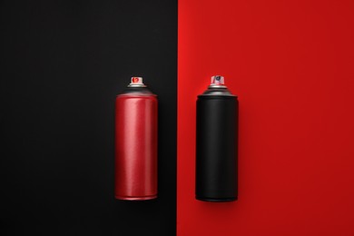 Photo of Cans of different graffiti spray paints on color background, flat lay