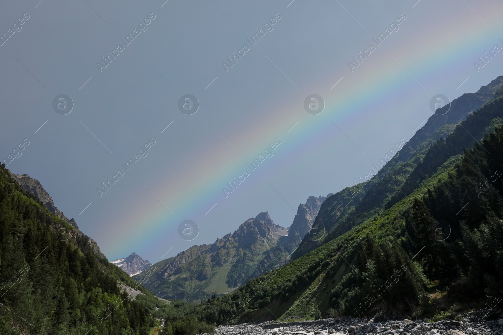 Photo of Picturesque view of beautiful rainbow over mountains