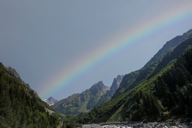 Photo of Picturesque view of beautiful rainbow over mountains