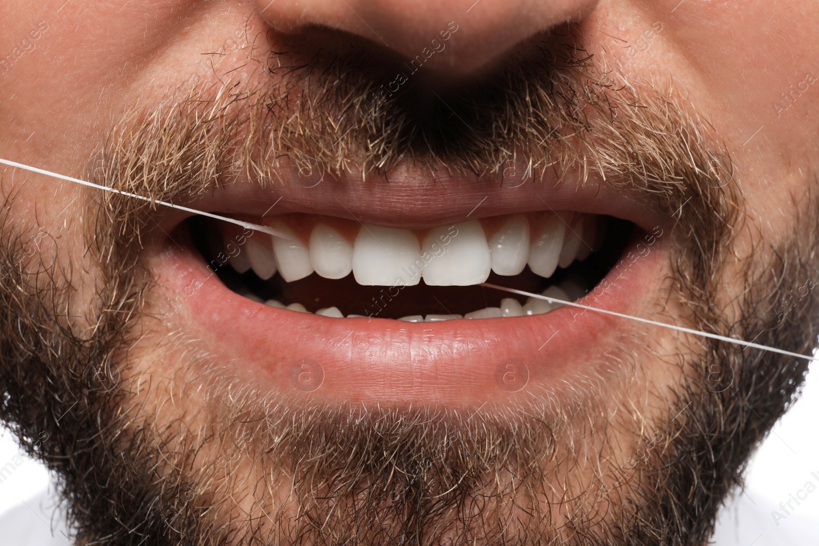 Photo of Man flossing his teeth, closeup. Dental care