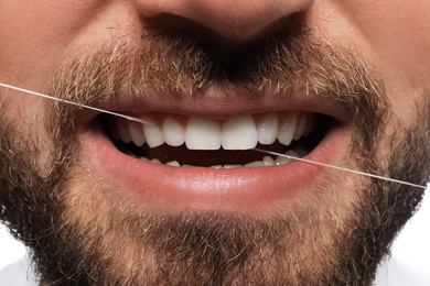 Photo of Man flossing his teeth, closeup. Dental care