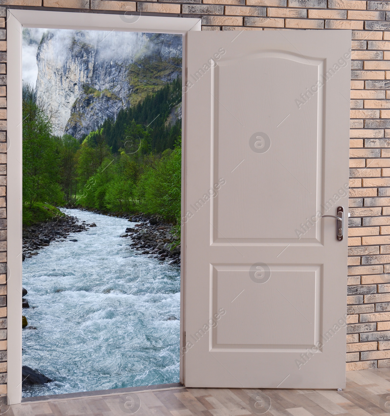 Image of Open door in brick wall inviting to visit mountains