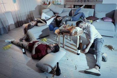Photo of Drunk friends sleeping in messy room after party