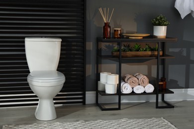 Modern bathroom interior with toilet bowl and console table