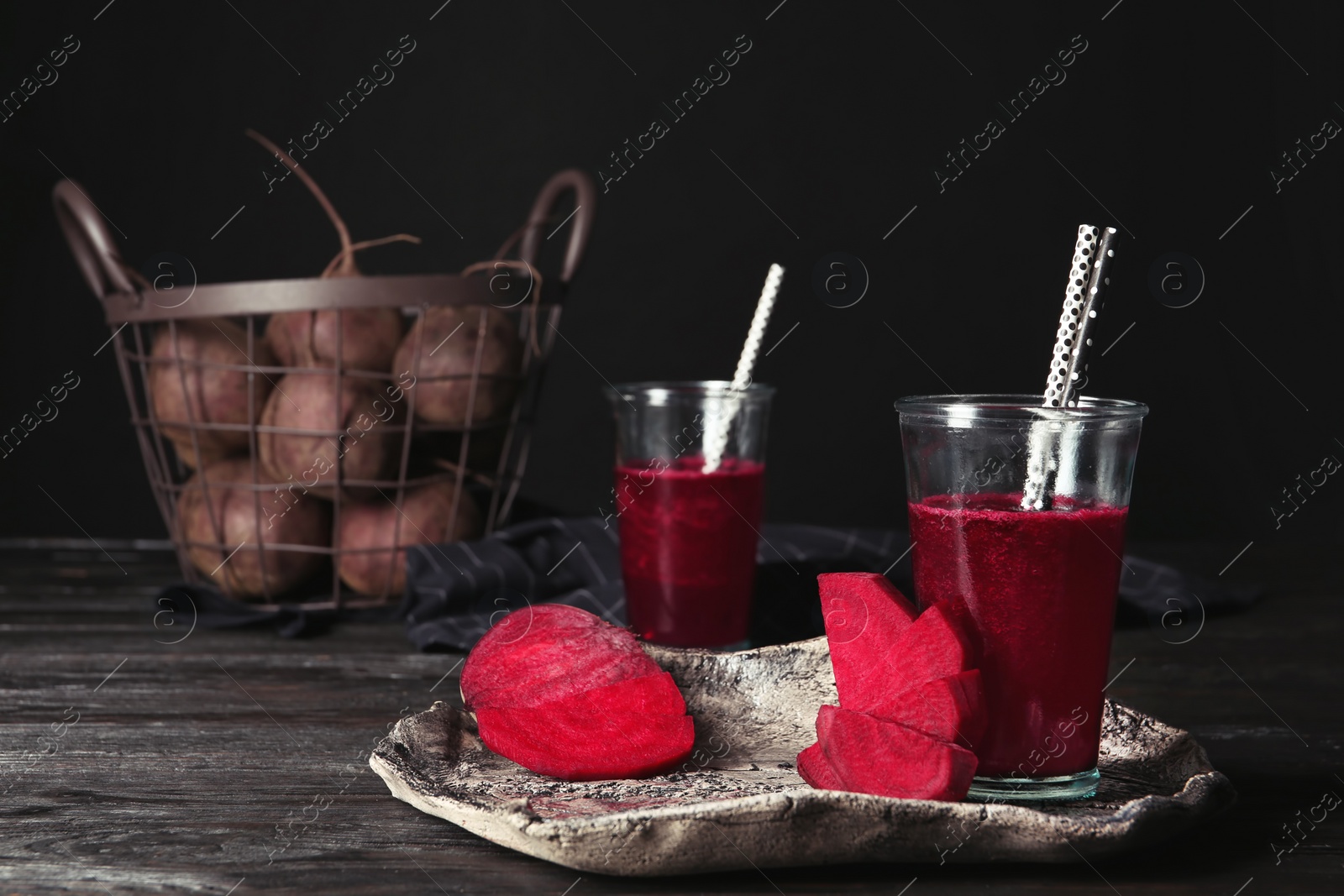 Photo of Plate with glass of beet smoothie on table