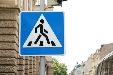 Photo of Post with Pedestrian Crossing road sign in city