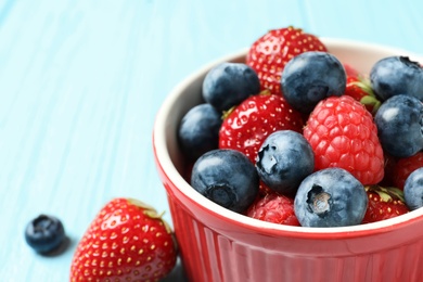 Photo of Bowl with raspberries, strawberries and blueberries, closeup