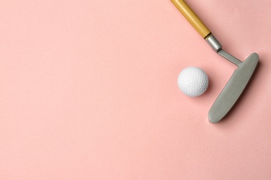 Golf ball and club on pink background, flat lay. Space for text