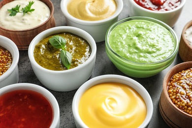 Photo of Set of different delicious sauces on table