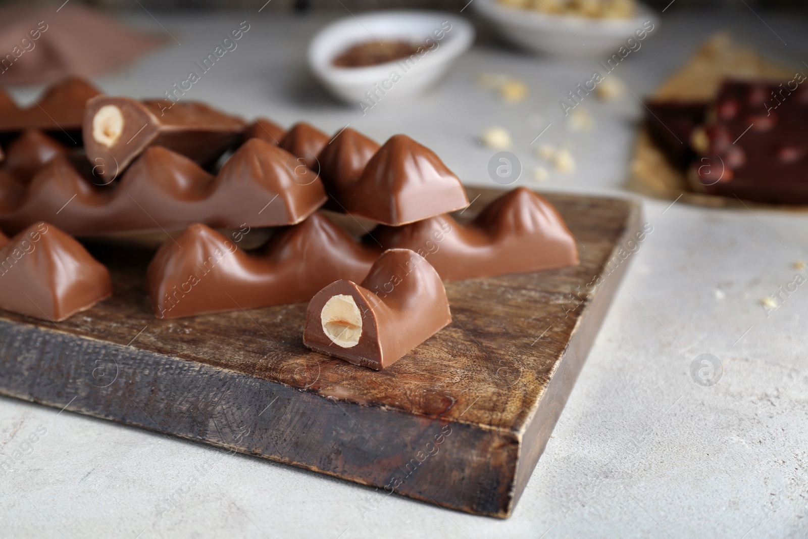 Photo of Tasty chocolate bars on light table, closeup. Space for text