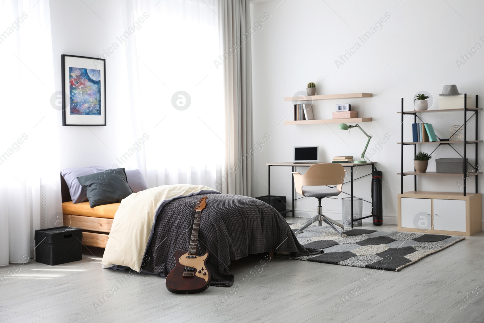 Photo of Modern teenager's room interior with workplace and bed