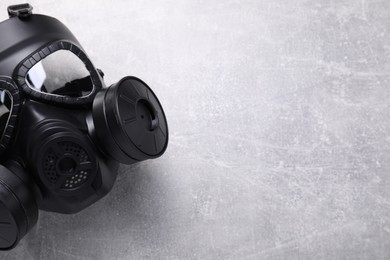 Photo of One gas mask on grey textured background, top view. Space for text