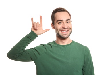 Photo of Man showing I LOVE YOU gesture in sign language on white background