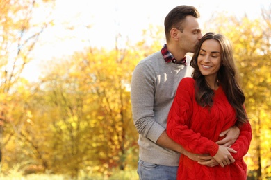 Photo of Happy couple in sunny park. Autumn walk