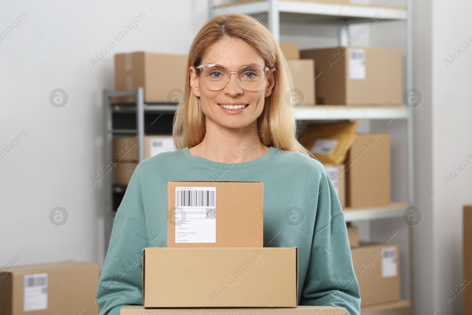 Photo of Seller with parcels in office. Online store